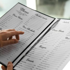 Person pointing at restaurant menu