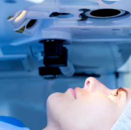 Person preparing for their procedure in the operating room wearing scrubs.