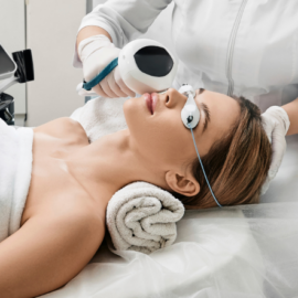 woman receiving Lumecca treatment with goggles on